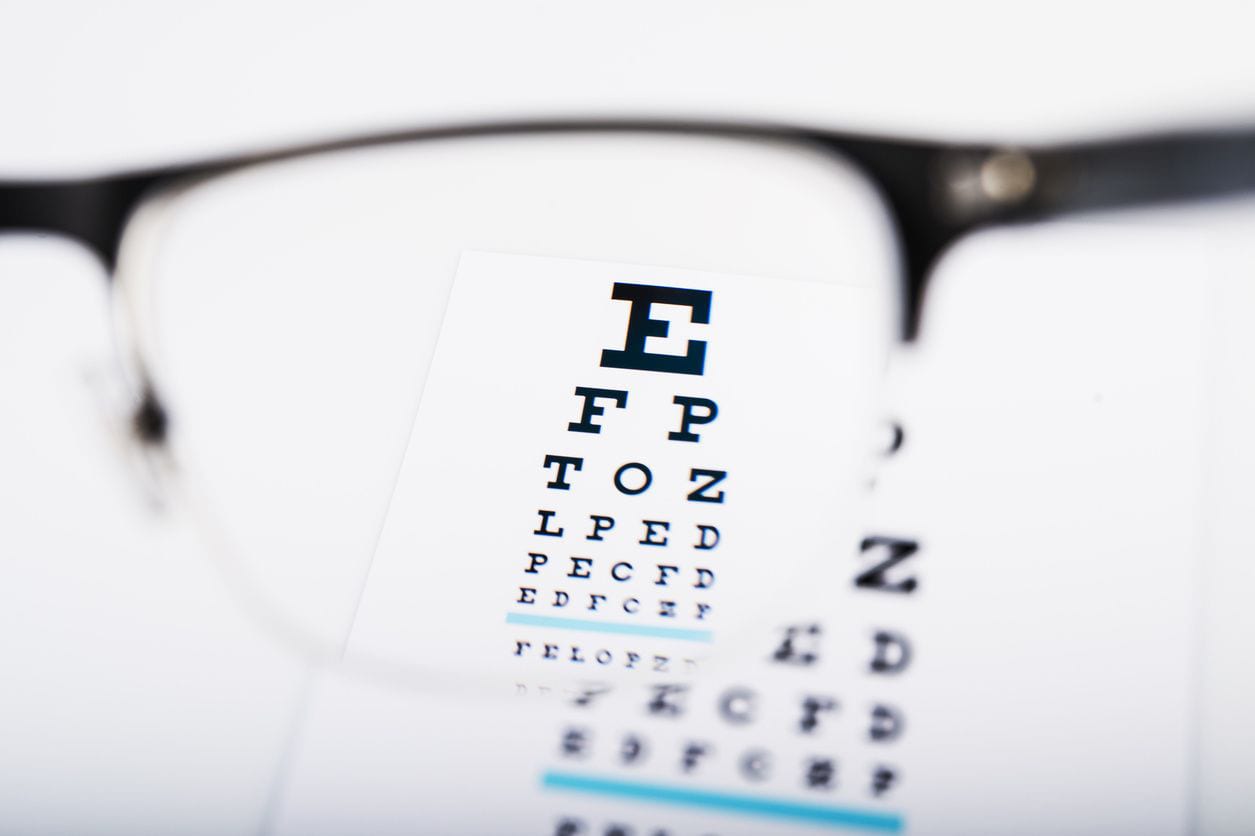 Eye chart viewed through eyeglasses lens.