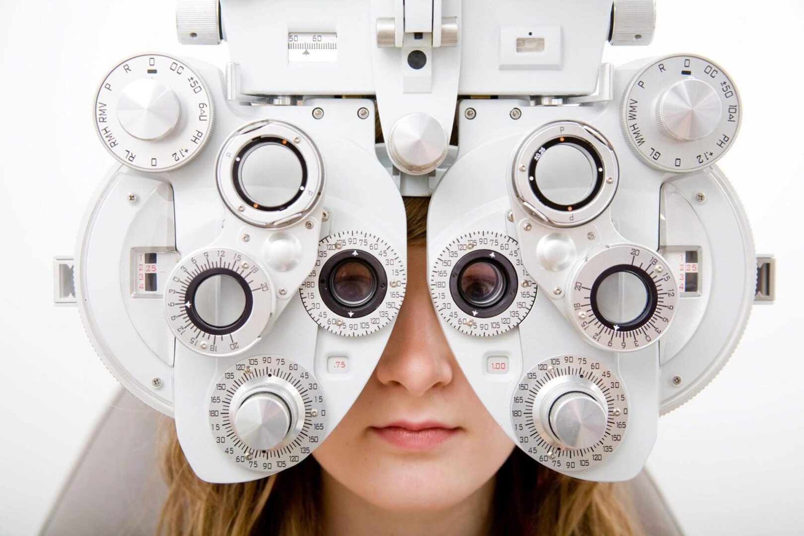 Person using a phoropter for eye exam.